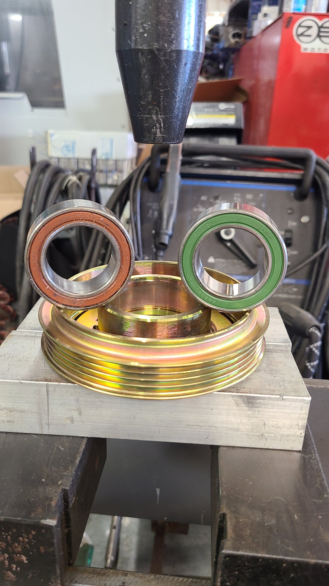 Old bearing in brown vs the new NSK bearing in green
